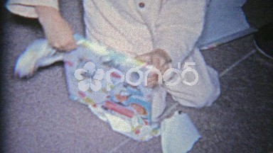 1963: Child opening a religious hymns psalms church book for Christmas gift.