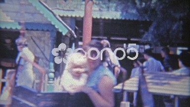 1962: Mom and baby enjoying dizzy hanging amusement park spinning ride at Knotts