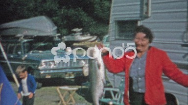 1966: Woman Catches Big Lake Trout at Trailer Park Campsite, Struggles with Weight