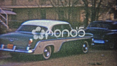 1959: Little dog running away from family trying to catch in front yard with