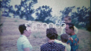 1954: Family Converses While Creepy Redhead Girl Stares at Camera.