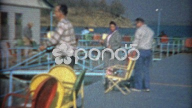 1964: Folks Fishing Off Colorful Pier in Blue Waters Lake