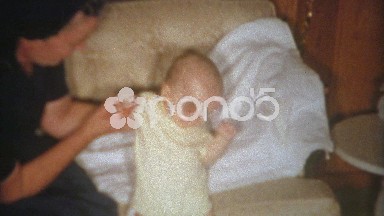 1964: Mom propping up baby's head from falling forward.