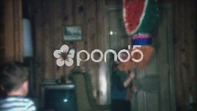 1966: Watermelon pinata breaks open and kids go crazy for candy.