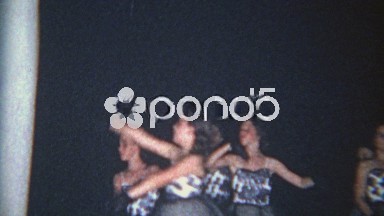 1966: Young Girl Dancing in Black Evening Gown with Dance Troupe
