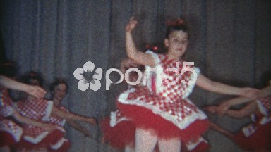 1969: Dance troupe in red checkered outfits performing on stage.