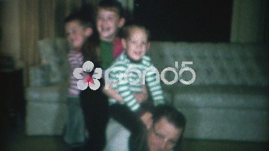1966: 3 kids having fun riding dad like a horse in the living room.