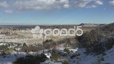 Timelapse downtown city behind mesa top after light winter snow dusting.