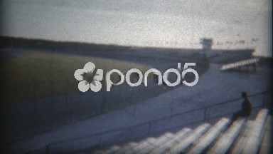 1960: Single racecar time trial race across empty grandstand crowd.