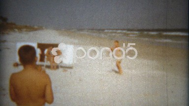 1960: Boys playing baseball catch on the ocean beach waved background.