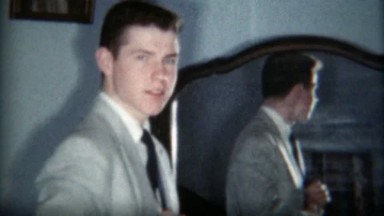 1957: Dapper Man Reflected in Mirror Getting Formally Dressed