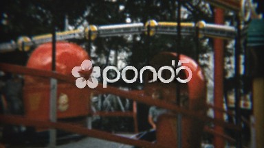 1959: Children riding tilt a whirl ride at fun amusement park.