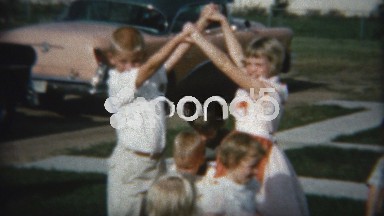 1958: Game of bridges, kids passing under the arms of older children.