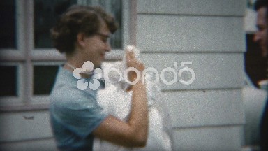 1958: 50's style parents show off new baby for first time to a camera.