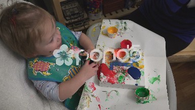 Baby dumping paint everywhere attempting to finger paint for 1st birthday.
