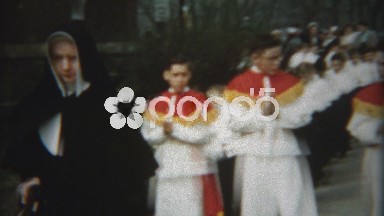 1954: Bashful boys 1st catholic communion walk led by nuns and priests.