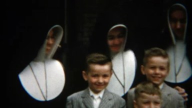 1955: Catholic nuns with pinstripe fashion suits smiling boys.