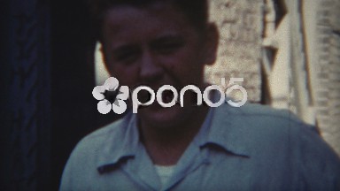 1954: Boys playing catch in the shade lined city street.