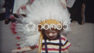 1954: Brothers dressed identically with native American Indian headdresses.