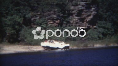 1954: Amphibious vehicle car boat going from land to water amongst rugged rocky