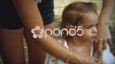1954: Girl dried off with towel by mother after summer pool swimming.