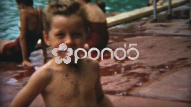 1954: Goofy boy slicking back hair at the public pool like the celebrities of