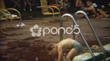 1956: Boy cautiously swims in public pool by himself for 1st time.