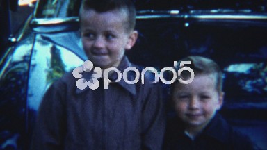 1954: Brothers smiling and jockey for position to be in the right spot.