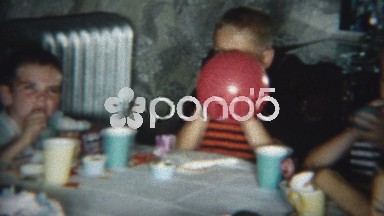 1954: Kid's birthday party blowing balloons up activity game.