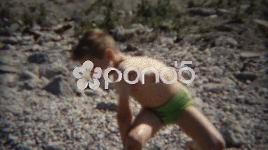 1954: Boy making funny face at beach that will freeze if he's not careful.