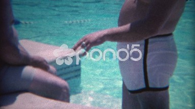 1965: Gangster shows off his diamond ring at exclusive poolside event.