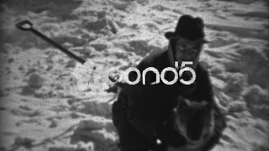 1936: Fedora hat man caring for dog in winter snowscape scene. SAXTON,