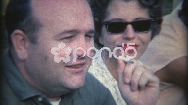 1965: Man Smoking Cigarette with Wife Lovingly Watching in Tampa, Florida