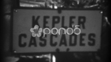 1937: Kepler Cascades waterfall high running fast tilt down follow river.