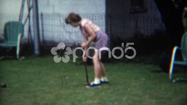 1956: Girl in Pink Tube Top Playing Croquet in Backyard Grass Field