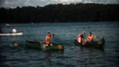 1955: Canoe Racing Across Lake at Summer Camp in Chicago