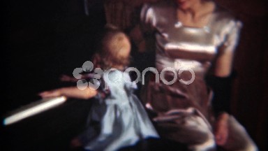 1954: Baby pounding on piano keys as mom tries to teach her subtlety.