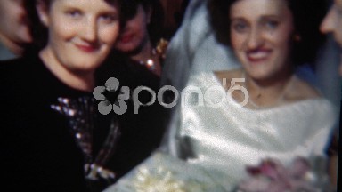 1954: Bride embarrassingly smiles while getting gift from loud mouth friend.