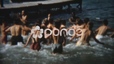 1955: Boys fighting in the lake water pulled apart by adults. CHICAGO