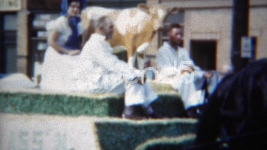 1951: Milk maid women parade float white dress blue bonnets traditional. ERIE,