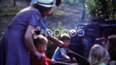 1953: Kids weenie roasting party hotdog condiments tables roasting party.