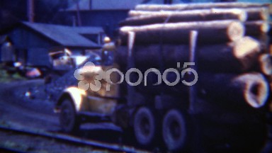 1949: Large truck carrying tree logs to lumber mill manufacturing plant.