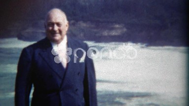 1949: Proud executive visiting the ocean on road trip across the continent. DEL