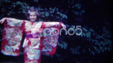 1949: Little caucasian girl in eastern asian kimono style winged dress. ERIE,