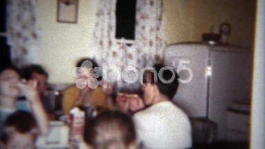1962: Family cozy at kitchen table enjoying late night snack. BUFFALO, NEW YORK