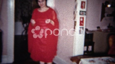 1962: Women showing off red cape dress Christmas holiday outfit. BUFFALO, NEW
