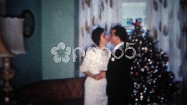 1962: Married couple celebrate Christmas with a quaint dance by the tree.