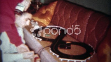 1962: Slot car race track makeshift setup on brown living room couch. BUFFALO,