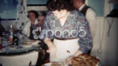 1963: Young jewish mother preparing meal for family guests in kitchen. BUFFALO,