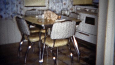 1963: Modest middle class retro lifestyle kitchen table stove and refrigerator.